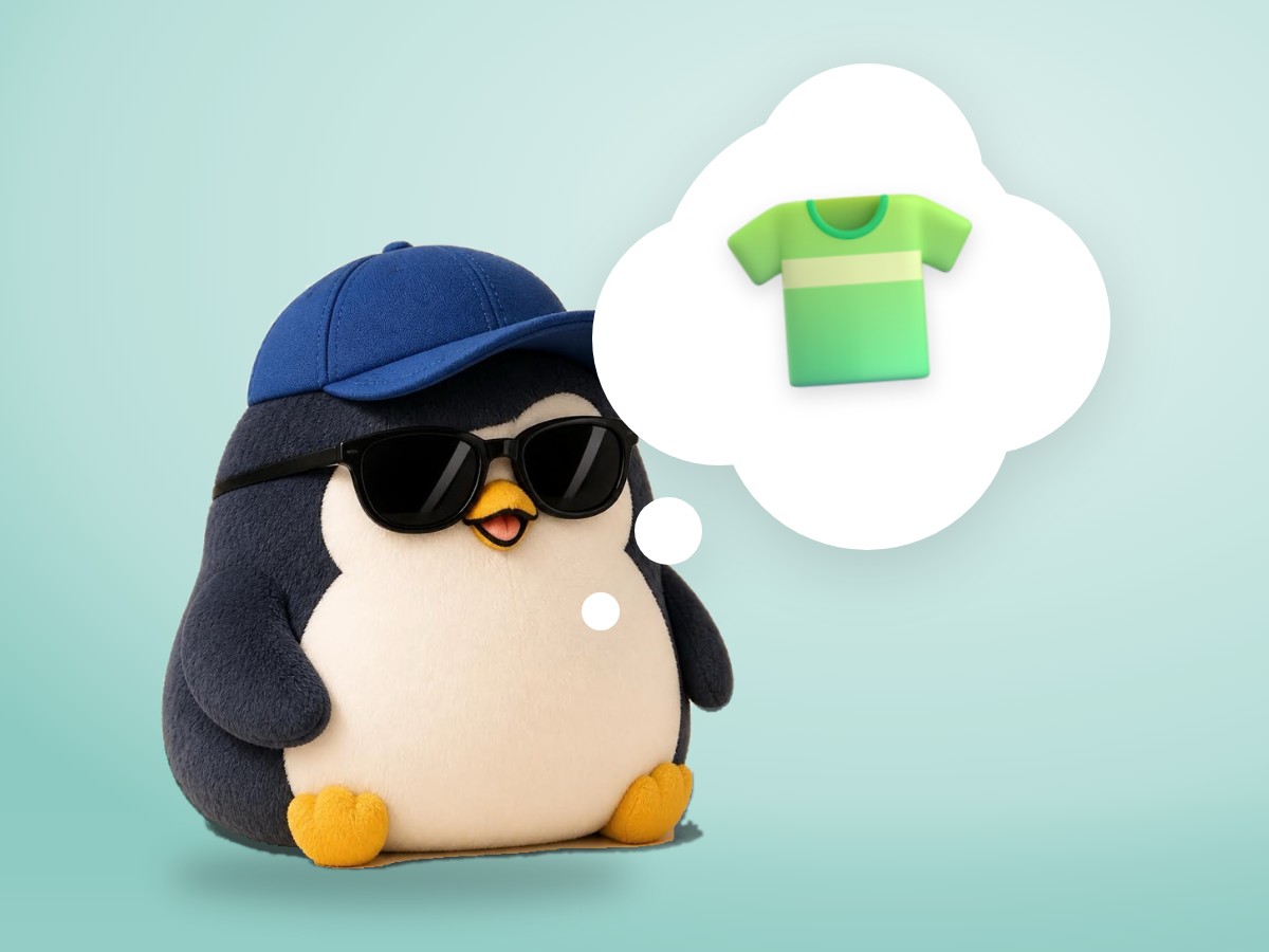 A layered cut paper diorama penguin wearing a slightly too big striped T-shirt and looking a little awkward