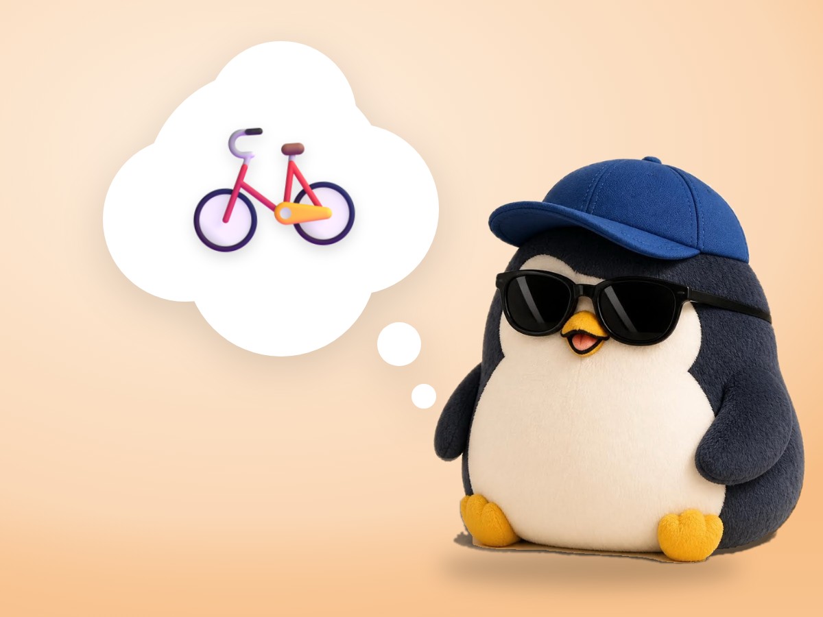 A chubby brushed mohair penguin riding a small bicycle with training wheels