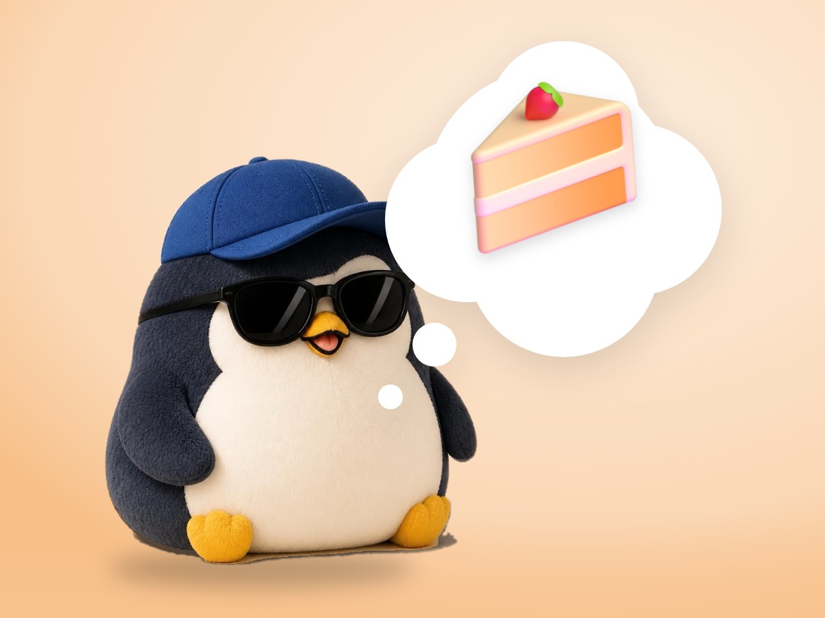 A boucle wool penguin sitting happily next to a slice of plain cheesecake on a small white plate