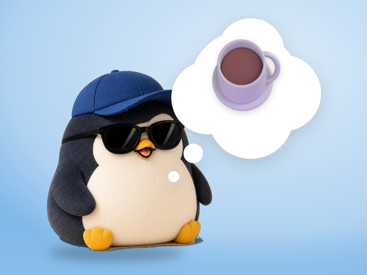A fluffy brushed mohair penguin happily holding one clean mug next to a neat, empty desk