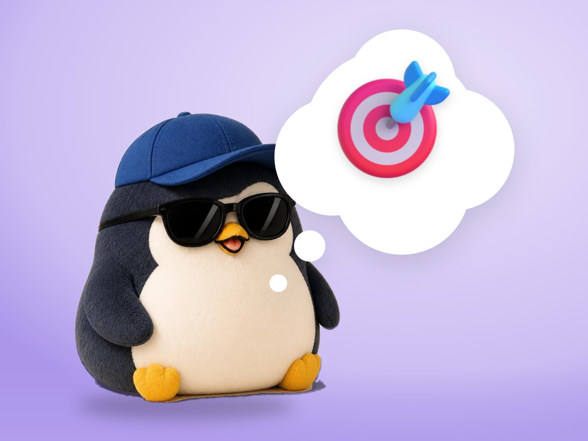 A chubby hand-embroidered felt penguin sitting inside a realistic wooden embroidery hoop
