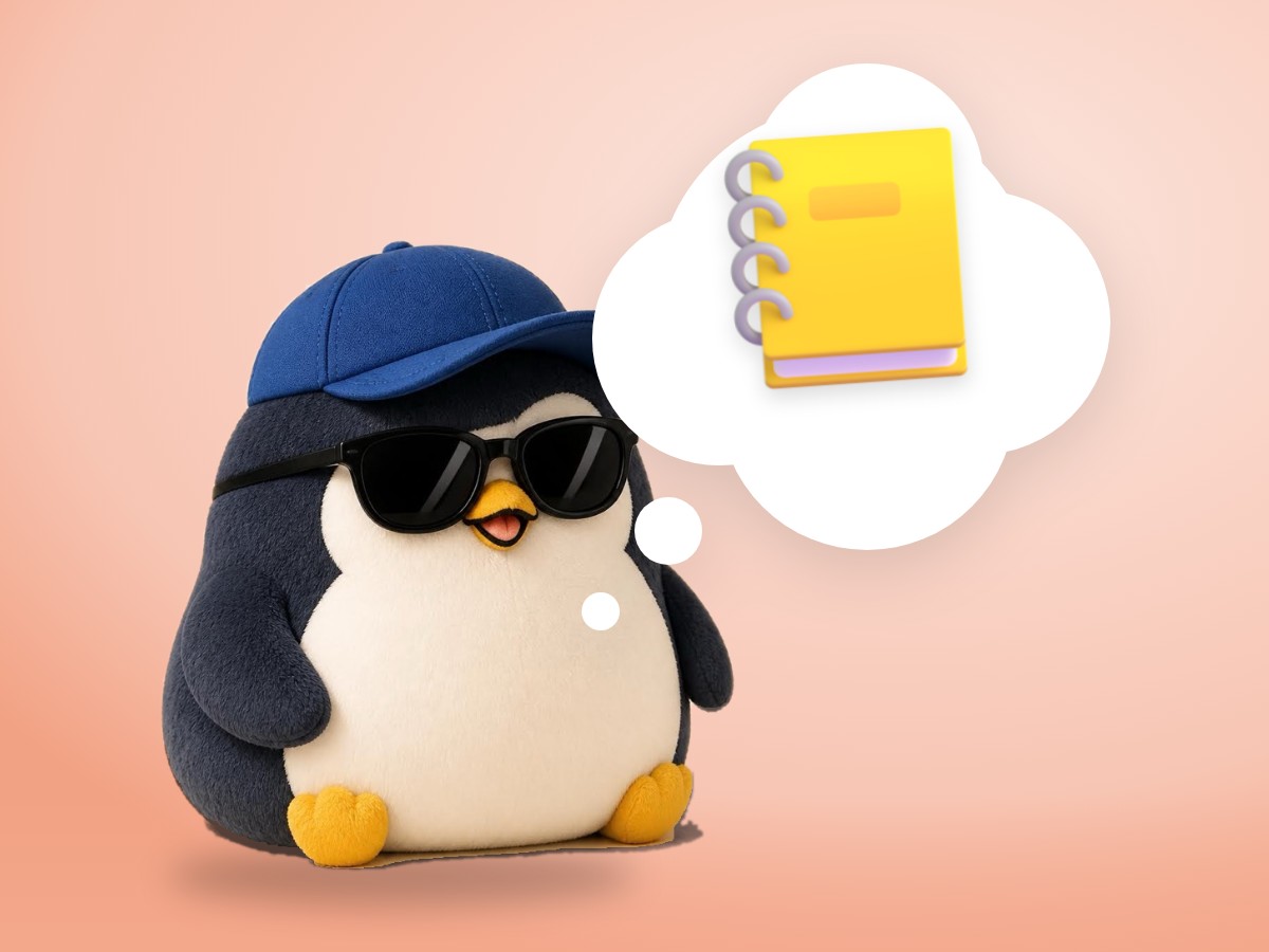 A crocheted penguin hugging an open notebook with a red ribbon bookmark