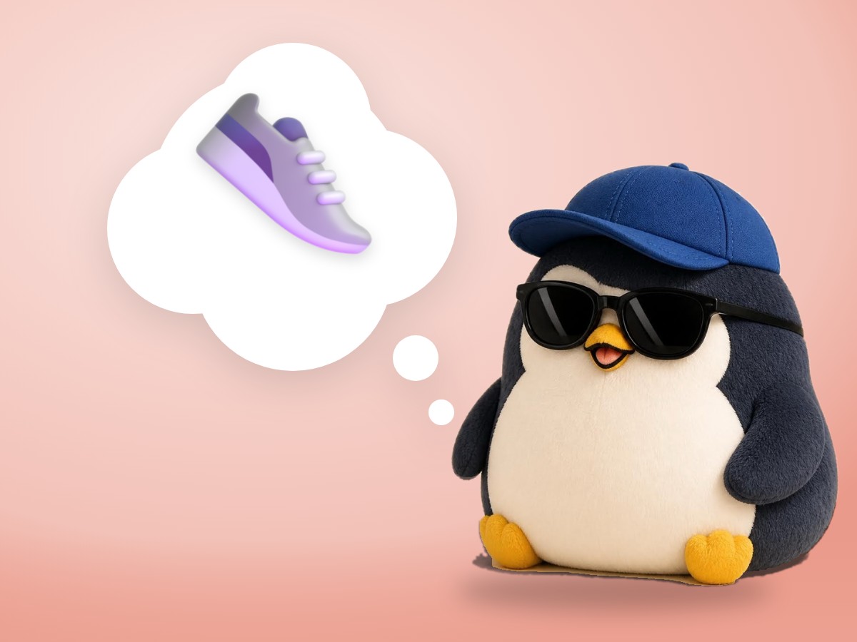 A crocheted amigurumi penguin looking at one tiny sneaker that is clearly too small for its foot