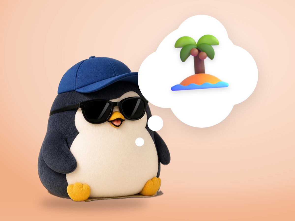 A chubby felted wool penguin sitting happily beside a real small wooden ladder lying on the sand of a tiny sunny island