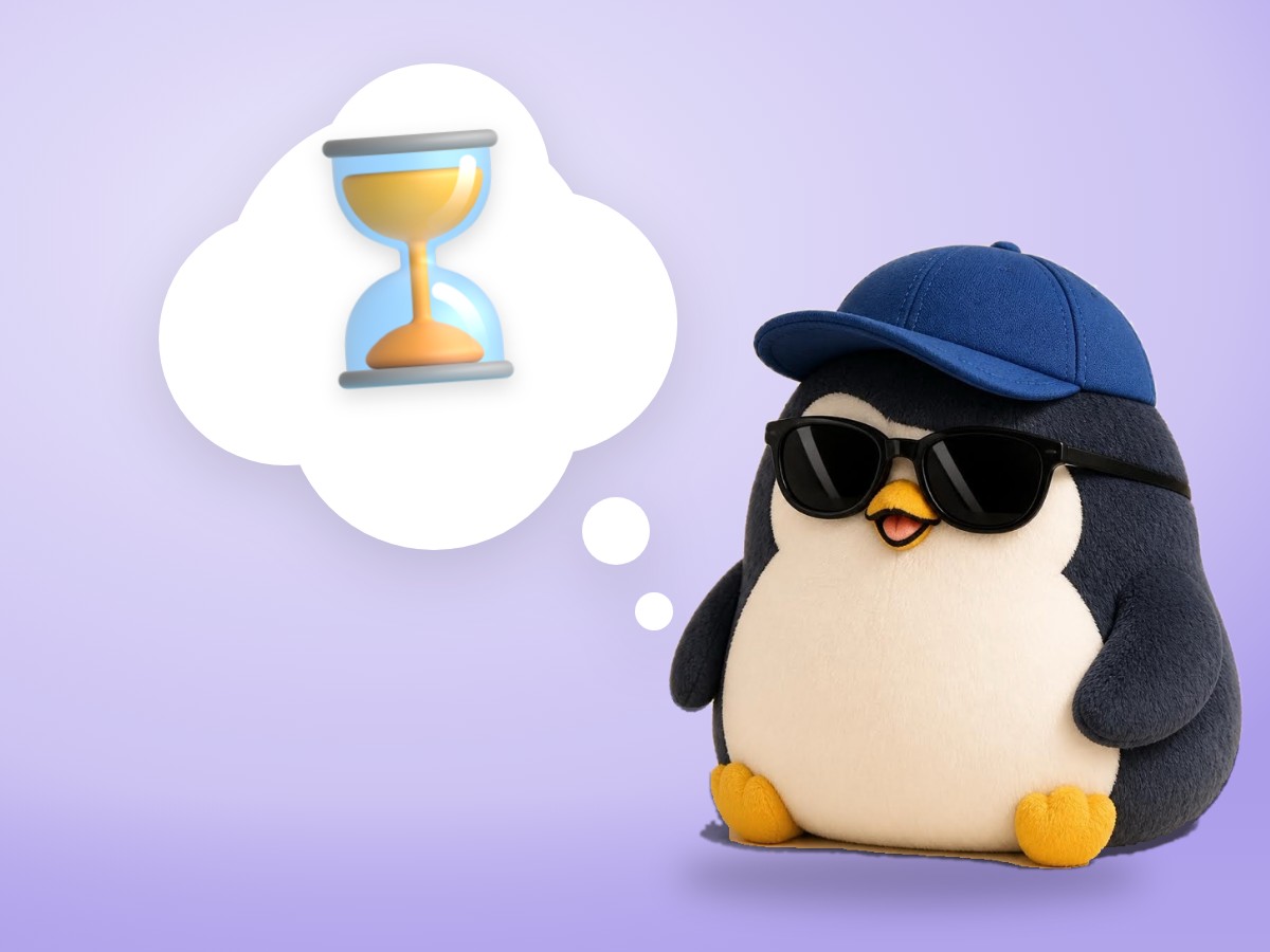 A matte plastic model kit penguin sitting calmly beside a small sand hourglass on a pastel desk