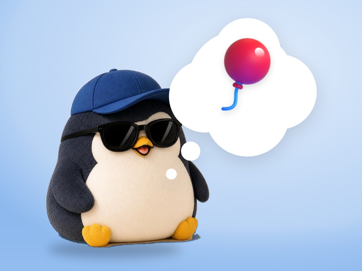 A chubby crocheted amigurumi penguin loosely holding the string of a real red balloon that sways in a light breeze
