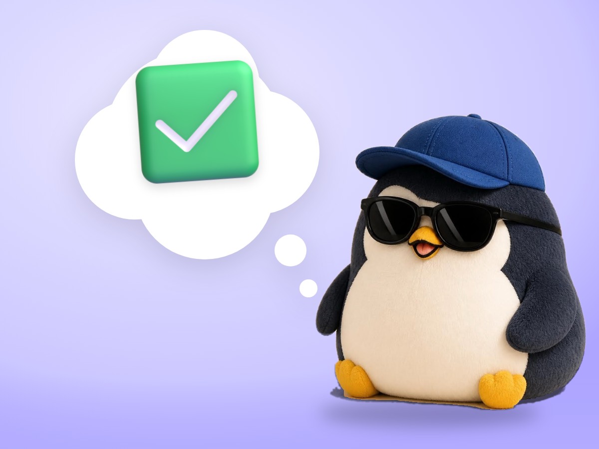 A chubby soft felted wool penguin holding a real yellow pencil next to one blank index card with a single check mark