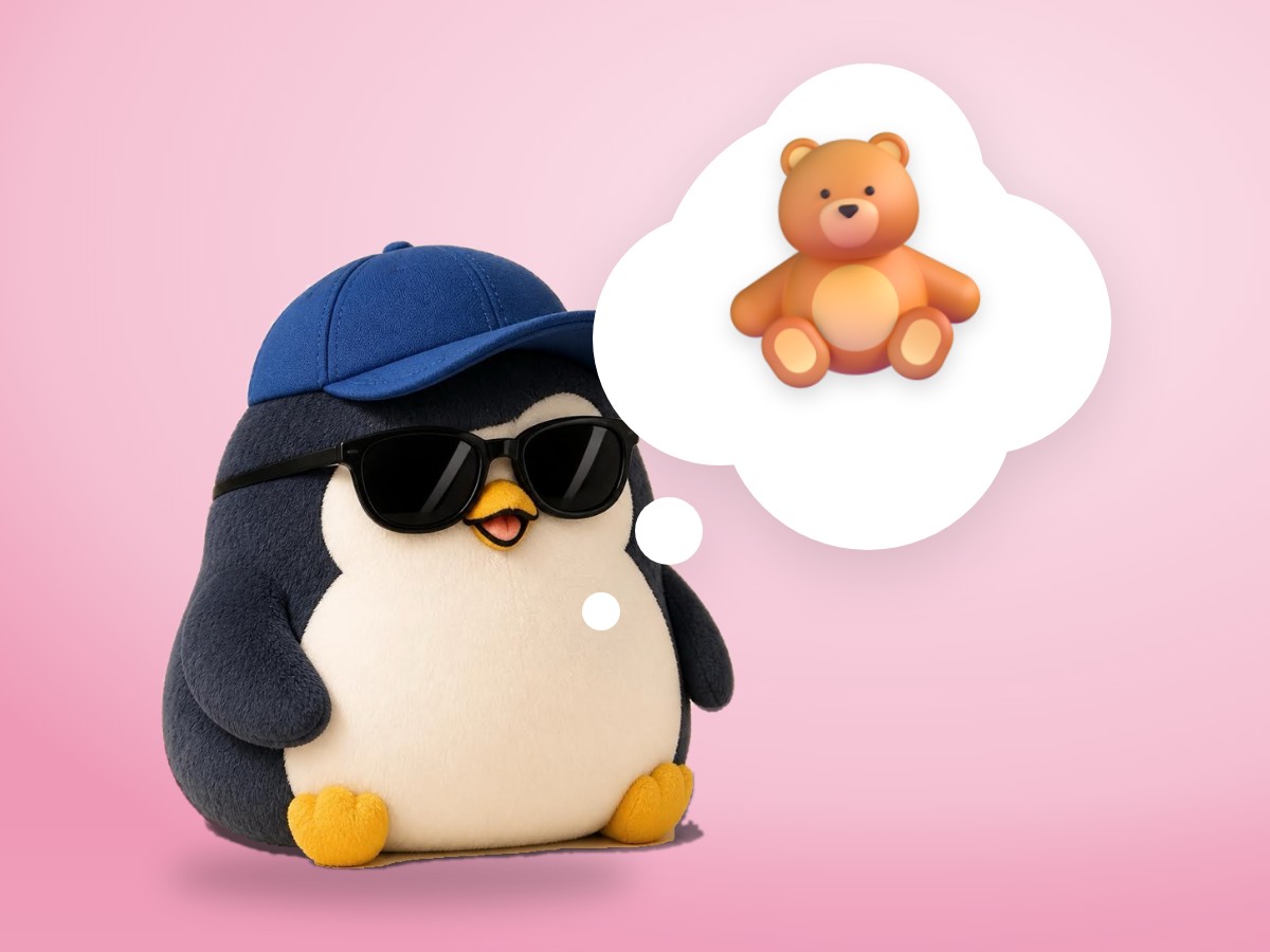 A chubby round chenille yarn penguin hugging the corner of a soft old cotton blanket against its cheek