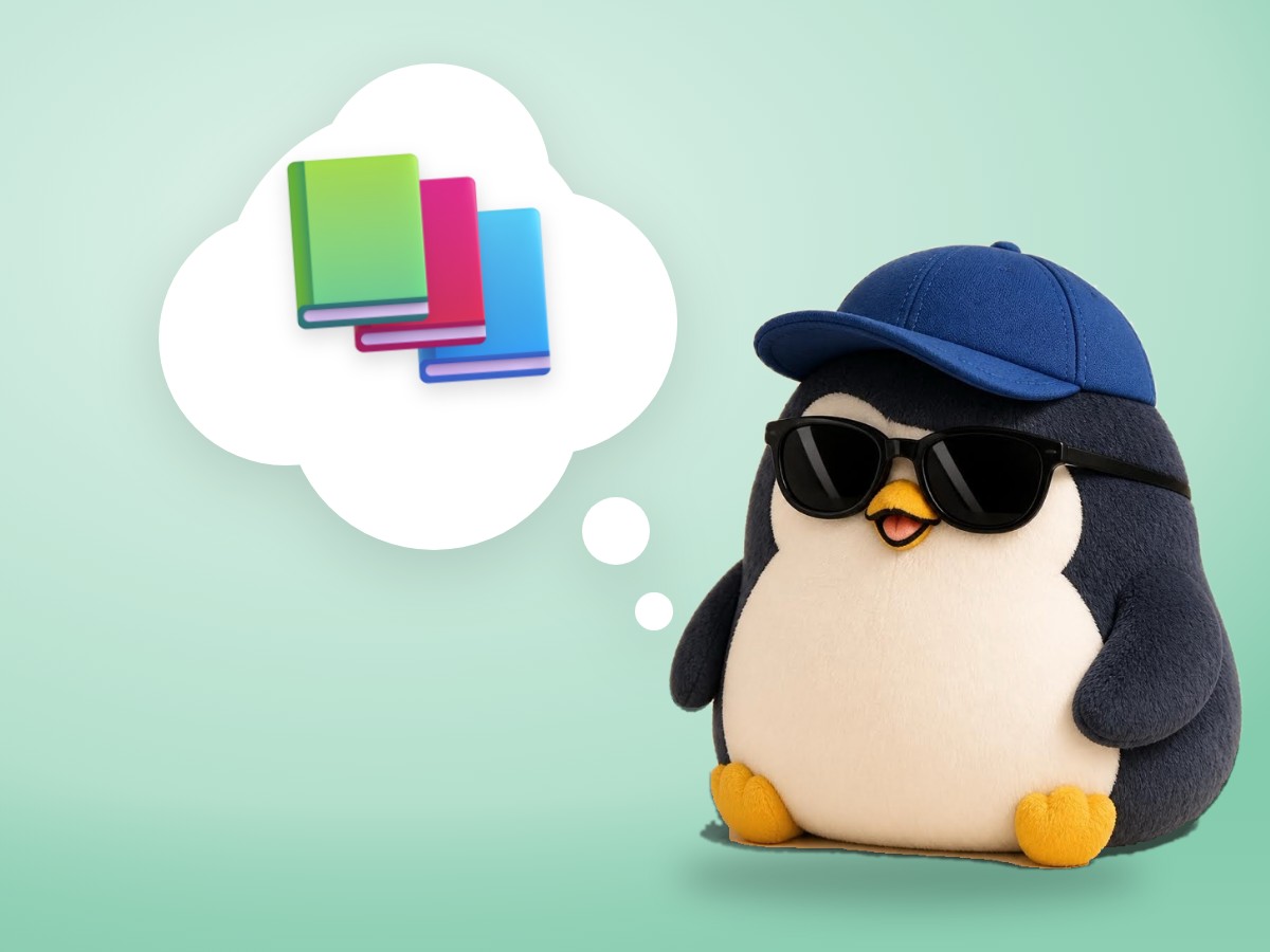 A hand-embroidered felt penguin reading one small open book with a bright sticky note in it