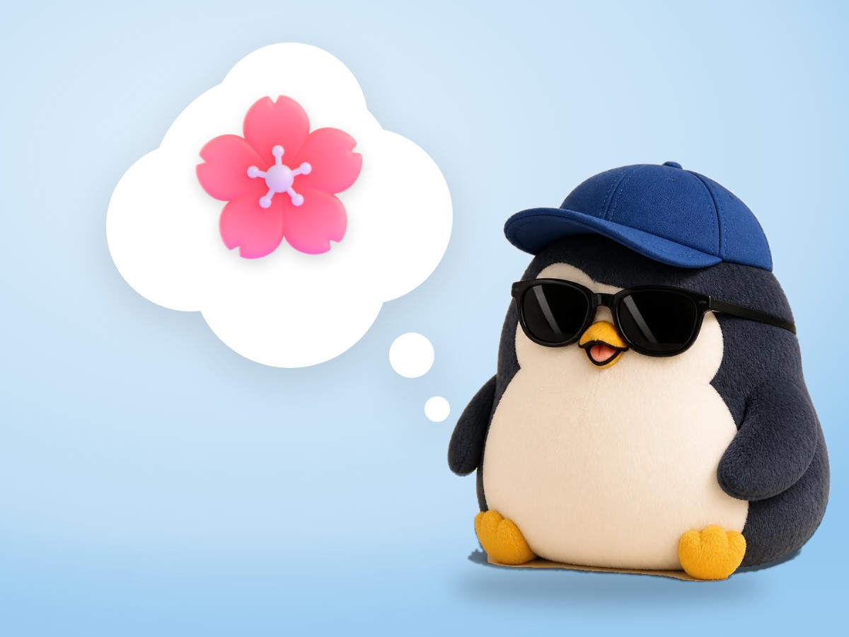 A chubby round hand-embroidered felt penguin happily looking up at a blooming cherry blossom branch