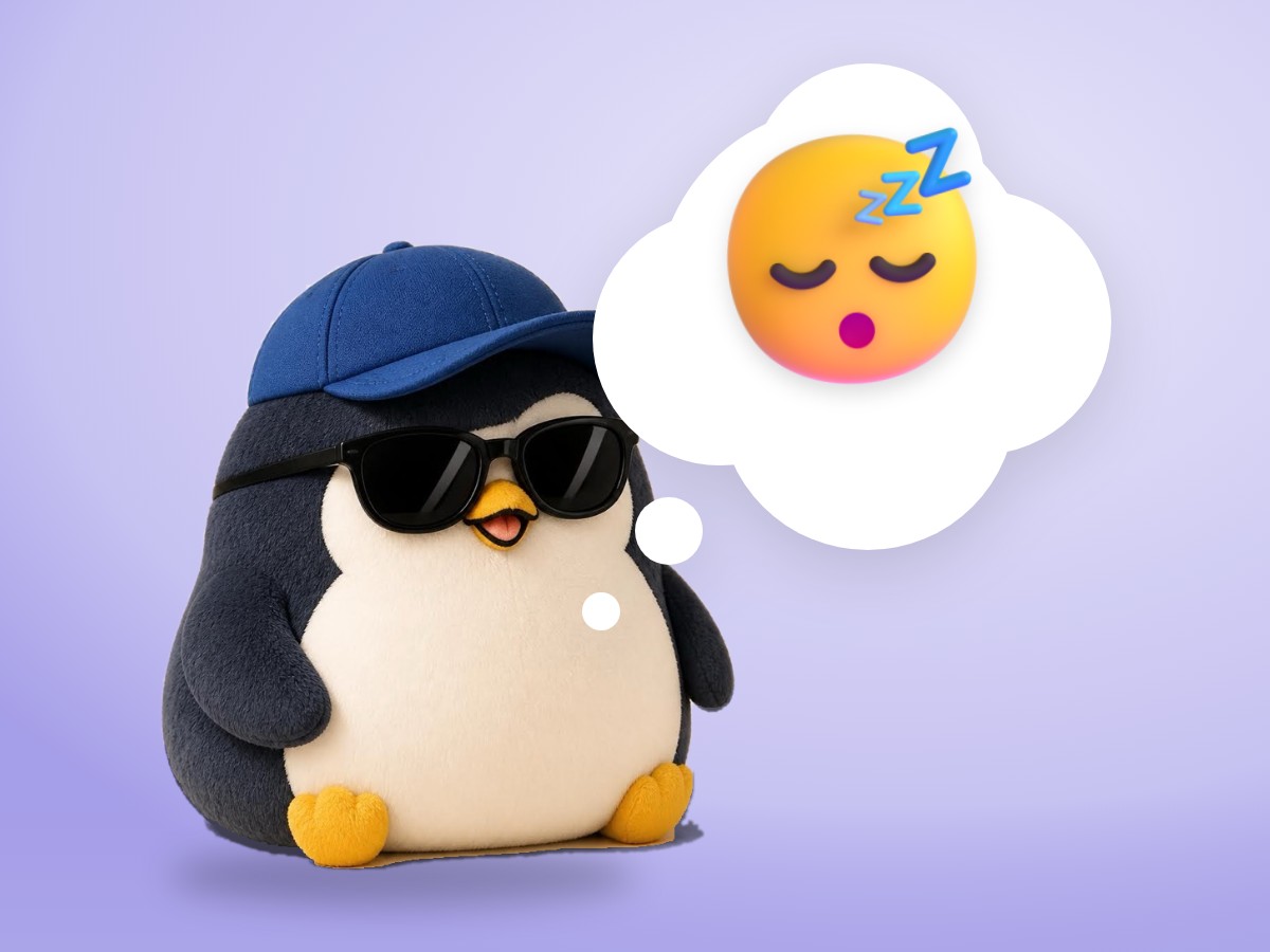 A chubby alpaca wool penguin sleeping peacefully with its head on a soft white pillow
