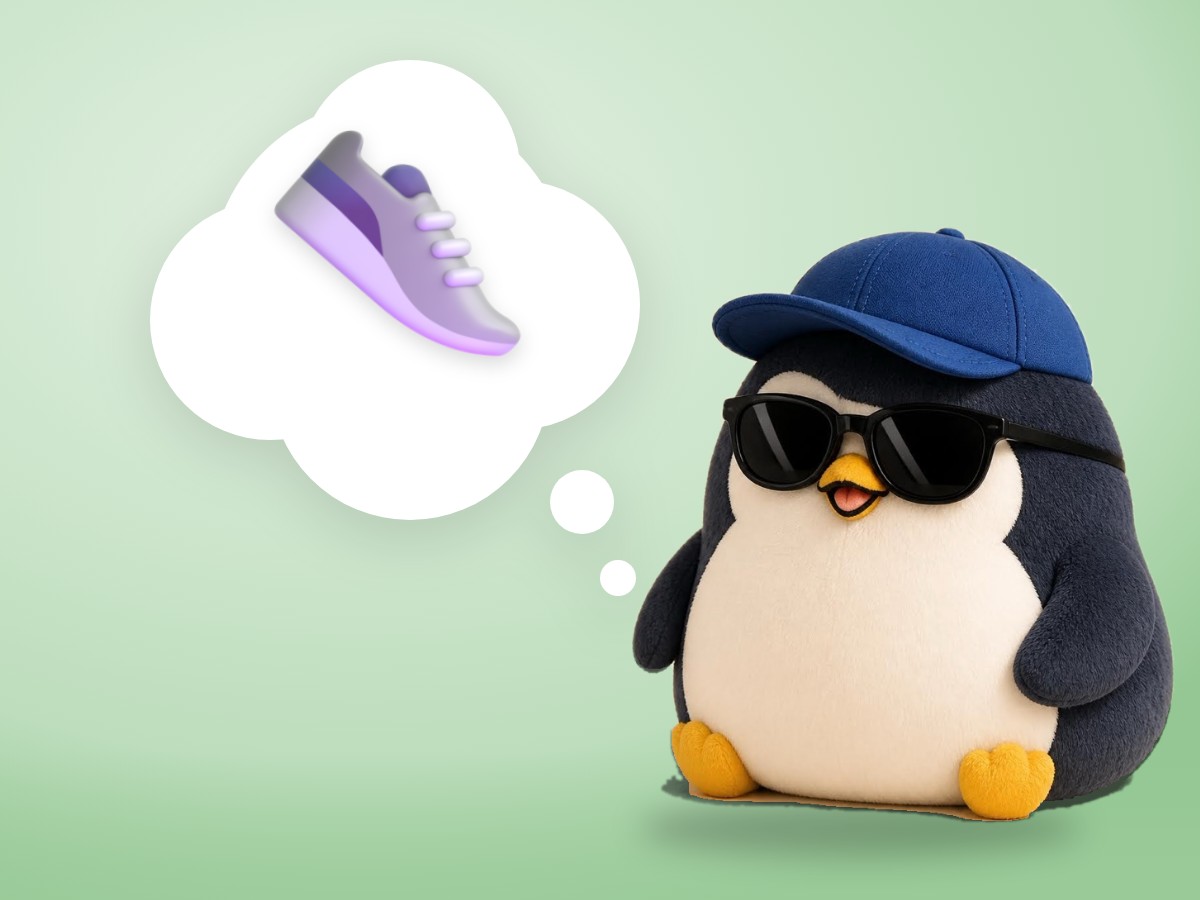 A chubby plush corduroy and felt penguin taking one small step forward in realistic tiny red sneakers on a sunny path