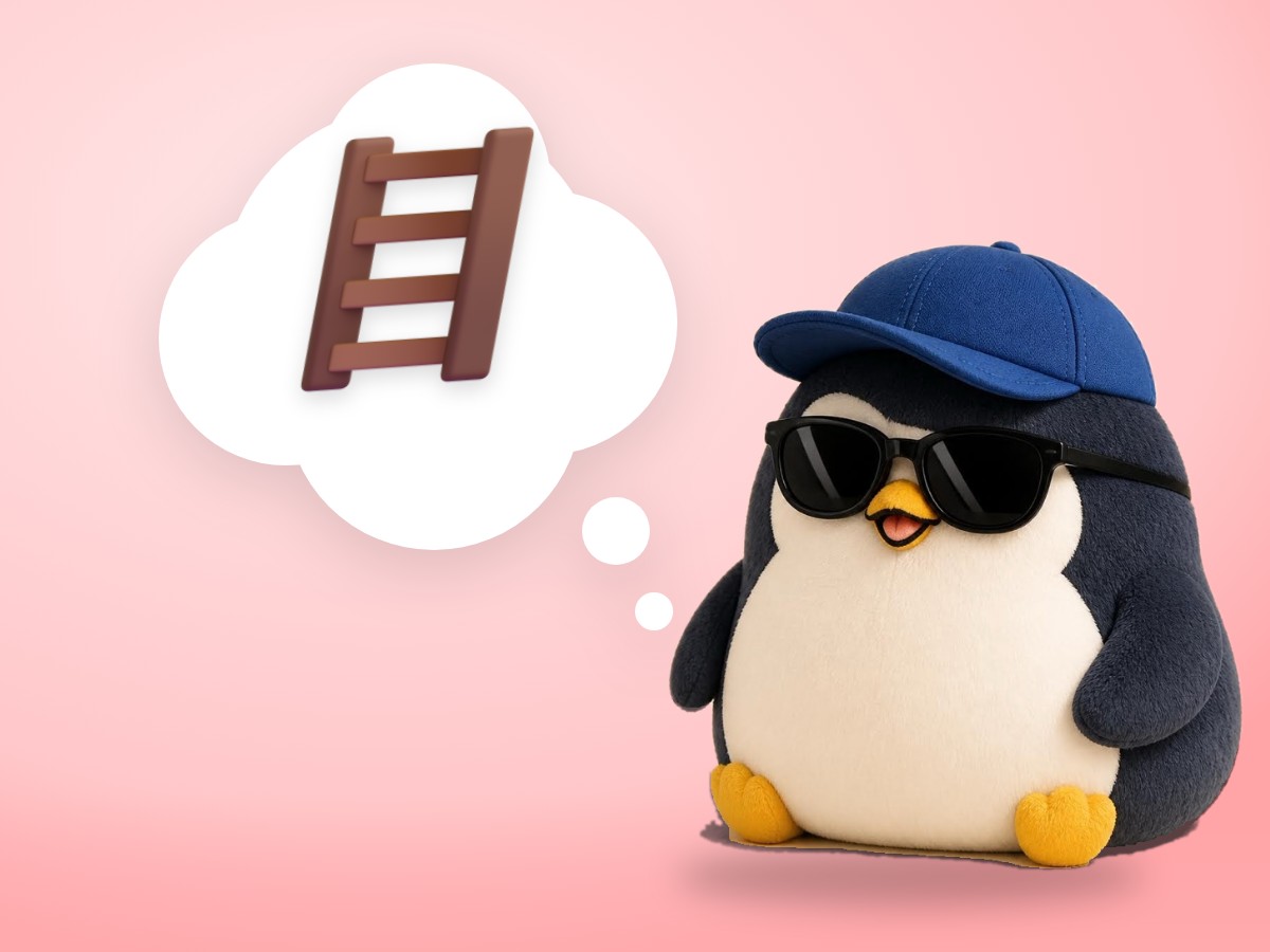 A chubby crocheted amigurumi penguin standing on a small real wooden step ladder holding a loaf of bread