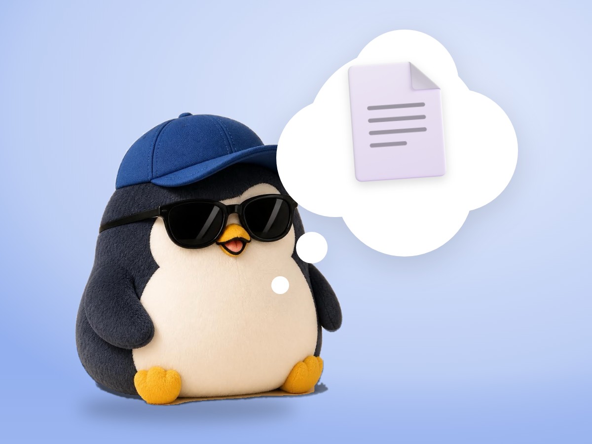 A chubby alpaca wool penguin standing on green grass and holding one real sheet of printed paper with both flippers