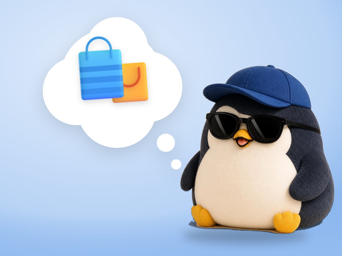 A chubby round boucle wool penguin happily holding a plain hardcover book in a softly blurred shop