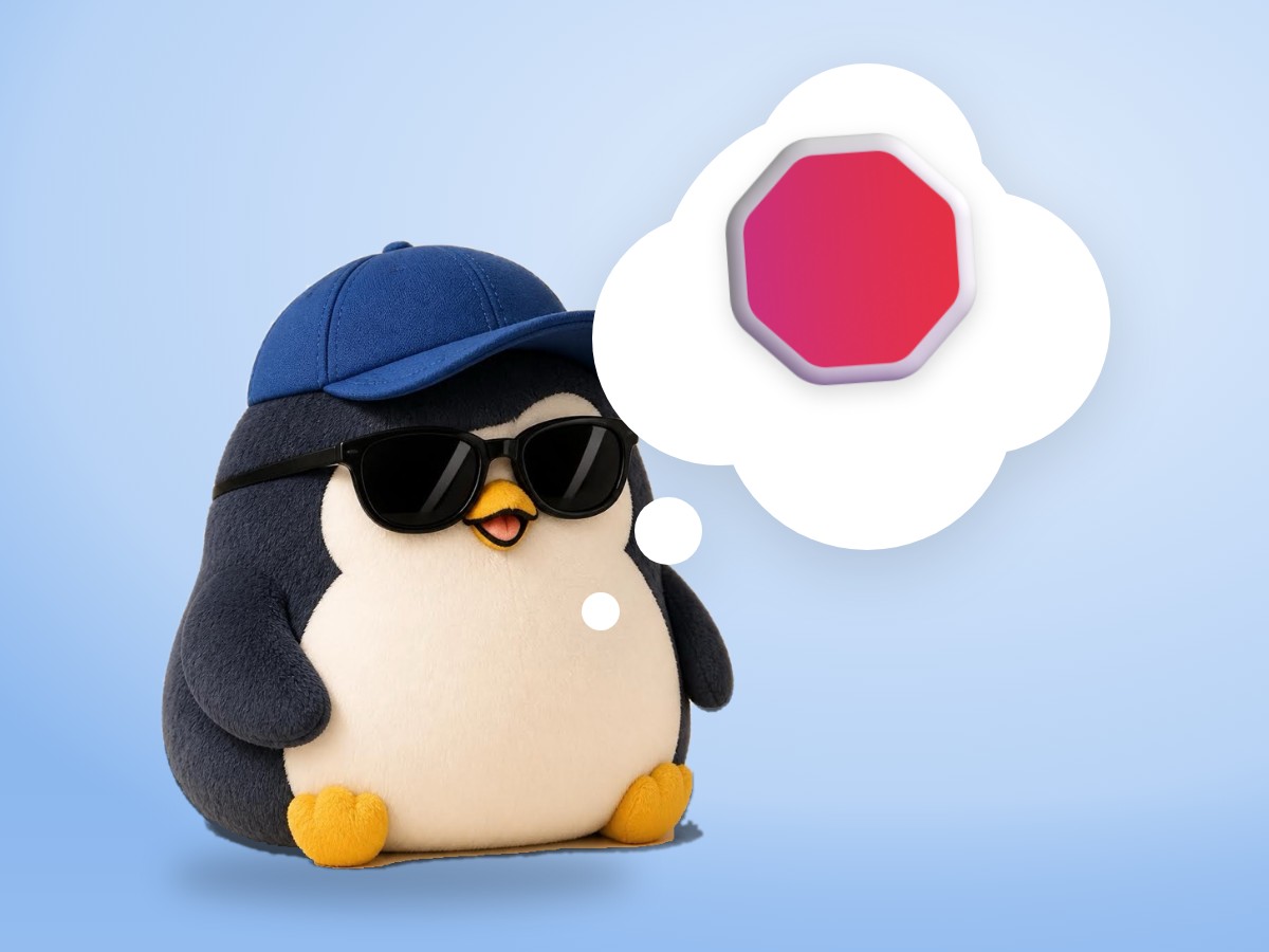 A chubby corduroy and felt plush penguin clapping its flippers next to a small realistic red stop sign