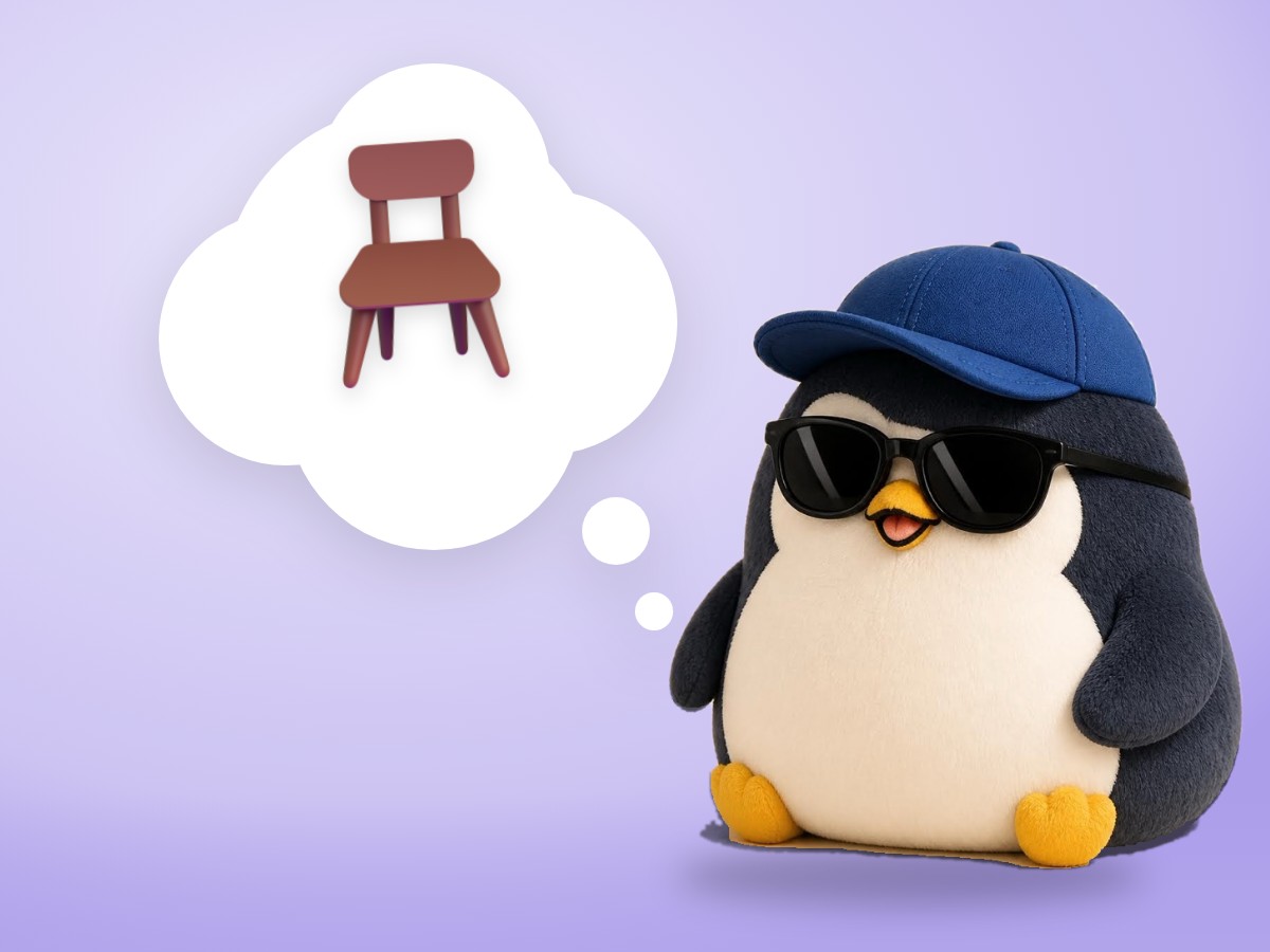 A hand-embroidered felt penguin sitting on a small wobbly wooden chair with a calm, slightly surprised face