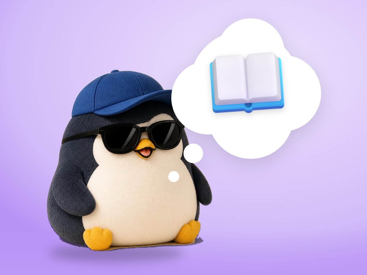 A chubby cut-paper penguin sitting on top of a thick closed dictionary with a ribbon bookmark