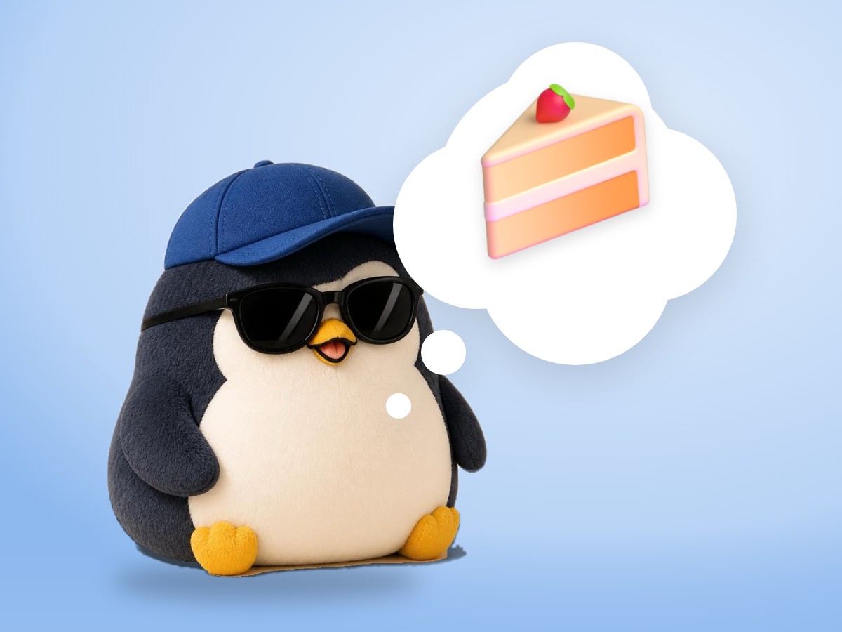 A chubby plush corduroy and felt penguin holding a fork next to a real strawberry shortcake on a small plate