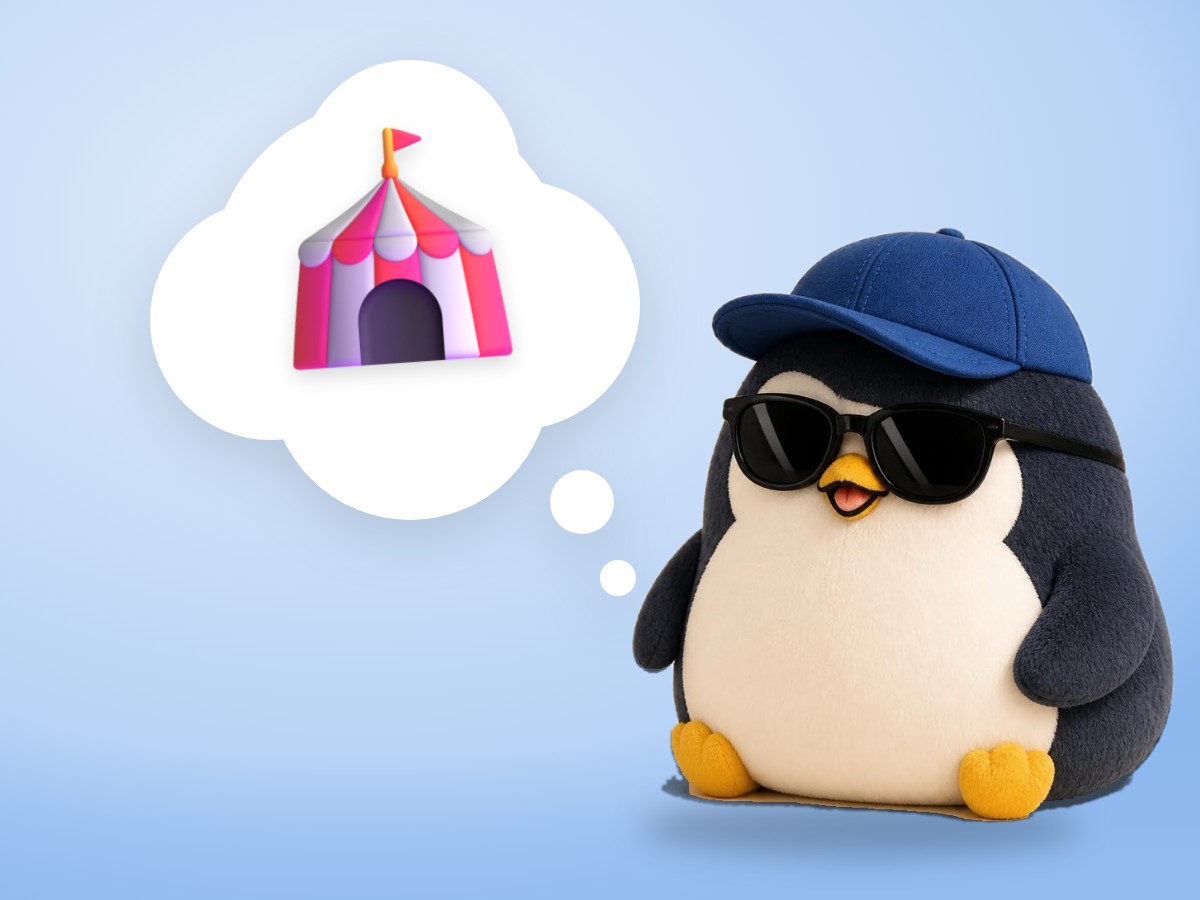 A chubby chenille yarn penguin holding one red ball calmly on a bright pink and turquoise background