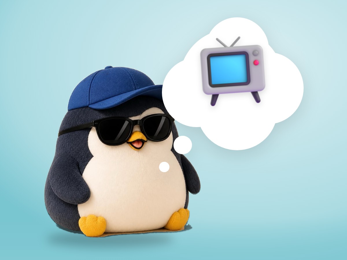 A chubby matte plastic model kit penguin holding a real TV remote control and pressing a big button